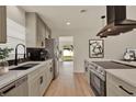Modern kitchen with stainless steel appliances, sleek cabinetry, and stylish black hardware at 5210 Poinsetta Ave, Winter Park, FL 32792