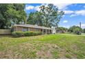 Charming one-story home features a spacious lawn and a red brick exterior at 5460 Se 28Th St, Ocala, FL 34480