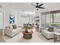 Bright living room with modern ceiling fan, open floor plan and light wood flooring at 6149 Metrowest Blvd # 103, Orlando, FL 32835