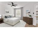 Serene bedroom featuring neutral tones, a ceiling fan, and lots of natural light at 6149 Metrowest Blvd # 103, Orlando, FL 32835