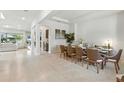 Bright, open dining room featuring a large table with seating for eight at 7613 Wandering Way, Orlando, FL 32836