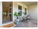 Inviting front porch with cozy seating, plants, and a welcome mat at 7613 Wandering Way, Orlando, FL 32836