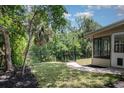 Serene backyard featuring a black metal fence, lush greenery, and a view of a natural preserve, perfect for outdoor relaxation at 917 Great Bend Rd, Altamonte Springs, FL 32714