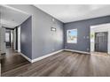 Open-concept living room with hardwood floors, light gray walls, and a bright, airy feel at 1257 N Pine Hills Rd, Orlando, FL 32808