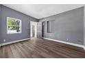 Bright living room featuring hardwood flooring, light gray paint, and exterior views at 1257 N Pine Hills Rd, Orlando, FL 32808