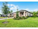 Beautiful home exterior showcasing lush green lawn and manicured landscaping at 1388 Lombardi Ct, Kissimmee, FL 34759