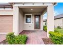 Inviting front porch with brick pavers and a decorative glass front door at 1388 Lombardi Ct, Kissimmee, FL 34759