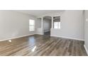 Spacious living room with hardwood floors, large windows, and decorative columns at 148 Conch Dr, Kissimmee, FL 34759
