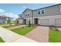 Attractive townhomes boast well-maintained landscaping and brick driveways for enhanced curb appeal at 16390 Bird Of Paradise Ave, Clermont, FL 34714