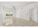 Well-lit empty living room with tile floors, ceiling fan and window at 2280 San Vital Dr # 101, Kissimmee, FL 34741