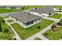 Aerial shot of a fenced backyard with green grass, a modern patio and ample space at 24401 Sunnys Halo Way, Sorrento, FL 32776