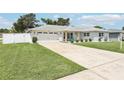 Beautifully renovated home with a large front lawn, spacious driveway, and two car garage at 2926 Carriage Dr, South Daytona, FL 32119