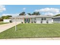 Attractive single-story home with a well-maintained lawn, inviting front porch and a two car garage at 2926 Carriage Dr, South Daytona, FL 32119