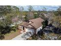 Aerial view of a well-maintained home with a spacious driveway and lush landscaping at 3013 Barrymore Ct, Orlando, FL 32835