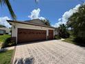Spacious three car garage with a beautifully patterned driveway at 3807 Plantation Blvd, Leesburg, FL 34748