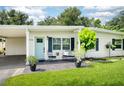 Inviting front porch with seating, landscaping, and a pleasant entryway to this adorable home at 4106 Alverado St, Orlando, FL 32812