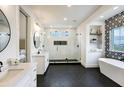 Modern bathroom with double vanity, frameless shower, soaking tub, and decorative tile wall at 4343 Juliana Lake Dr, Auburndale, FL 33823