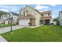Beautiful two-story home with green lawn and stone accents on the attached two car garage at 5365 Rocking Horse Pl, Oviedo, FL 32765