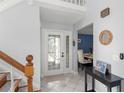 Bright foyer with a decorative glass front door and a view into the dining room at 5365 Rocking Horse Pl, Oviedo, FL 32765