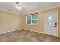 Bright living room with tile flooring, a ceiling fan, and a large window offering plenty of natural light at 540 W Columbia St, Lake Alfred, FL 33850