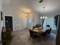Dining room with modern flooring and large windows providing ample natural light at 6026 Canyon De Chelley Ct, Orlando, FL 32810
