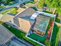 Aerial view showcasing a sparkling screened-in pool, lush landscaping, and fenced-in yard at 680 Cheoy Lee Cir, Winter Springs, FL 32708