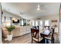 Open living area features a ceiling fan, laminate floors, and a large dining space at 680 Cheoy Lee Cir, Winter Springs, FL 32708