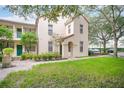 Exterior of a two-story home with green lawn and partial landscape at 710 Siena Palm Dr # 104, Celebration, FL 34747