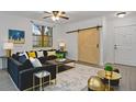 A beautifully staged living room featuring a black velvet sofa and a decorative rug at 710 Siena Palm Dr # 104, Celebration, FL 34747