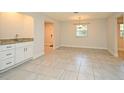 Open living room area featuring tile floors, neutral paint, wet bar and natural light at 7104 Olympia Ct # 7104, Longwood, FL 32779