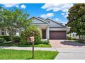 Beautiful house with a paved driveway and a well-manicured front yard at 8713 Iron Mountain Trl, Windermere, FL 34786