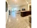 Open floor plan featuring a modern kitchen, dining area, and a spacious living room at 9033 Alba Ln, Kissimmee, FL 34747