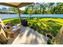 Backyard patio area with a grill and outdoor seating, perfect for entertaining at 113 San Mardeen Ct, Daytona Beach, FL 32117