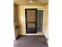 A unit entryway featuring a storm door, a small window, and unit number marker at 120 Hibiscus Woods Ct # 11B, Deltona, FL 32725