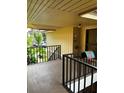 Covered porch area with black metal railings and neutral-colored paint at 120 Hibiscus Woods Ct # 11B, Deltona, FL 32725