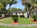 A well-maintained home with manicured lawn, trimmed hedges, and colorful accent landscaping at 1310 Briarwood Ave, Deltona, FL 32725