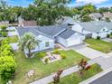 Bird's eye view of a well-maintained single-story home with a two-car garage and lush landscaping at 1322 Ravida Woods Dr, Apopka, FL 32703