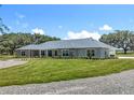 Charming exterior with stone accents, manicured lawn, and attached garage at 14243 County Road 450, Umatilla, FL 32784