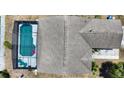 An overhead view shows the roof of this home and its screened-in swimming pool at 1614 Oak Hill Trl, Kissimmee, FL 34747