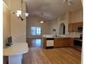 Bright kitchen with updated appliances, laminate floors, and an open layout to the living space at 1797 Tillstream Dr, Orlando, FL 32818