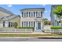 Charming two-story home featuring a white picket fence and an inviting covered front porch at 183 Longview Ave, Kissimmee, FL 34747