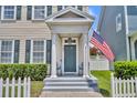 Inviting front porch featuring classic columns and an American flag waving proudly at 183 Longview Ave, Kissimmee, FL 34747