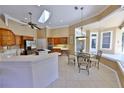 Spacious kitchen with island cooktop, breakfast nook, and pool views at 204 Quail Trail Ct, Lake Mary, FL 32746