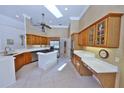 Well-lit kitchen featuring granite countertops, island cooktop, and stainless steel appliances at 204 Quail Trail Ct, Lake Mary, FL 32746