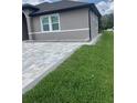 Exterior showing a new paver driveway and green lawn of this charming home at 2420 Graham Dr, Orlando, FL 32807