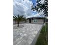 Charming home featuring a new paver driveway leading to the front entrance at 2420 Graham Dr, Orlando, FL 32807
