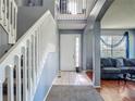 Inviting foyer with staircase and view into the living room with hardwood floors at 2530 The Oaks Blvd, Kissimmee, FL 34746