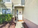 Charming entryway with a white front door, decorative wreath, and neatly kept landscaping at 2530 The Oaks Blvd, Kissimmee, FL 34746
