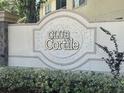 Photo of the Club Cortile sign with plants and trees in the background on a sunny day at 2770 Club Cortile Cir # A, Kissimmee, FL 34746