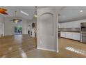 Open-concept layout showcasing the living room with wood floors and adjacent kitchen at 3196 Verbena Ct, Deltona, FL 32725